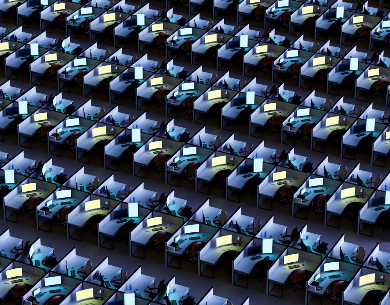 a room filled with lots of desks covered in monitors